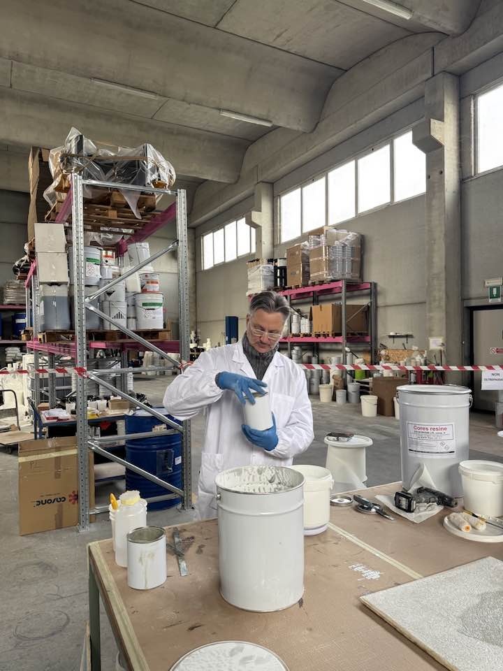 Alessandro Nallio al banco di laboratorio, con campioni e contenitori di materiale
